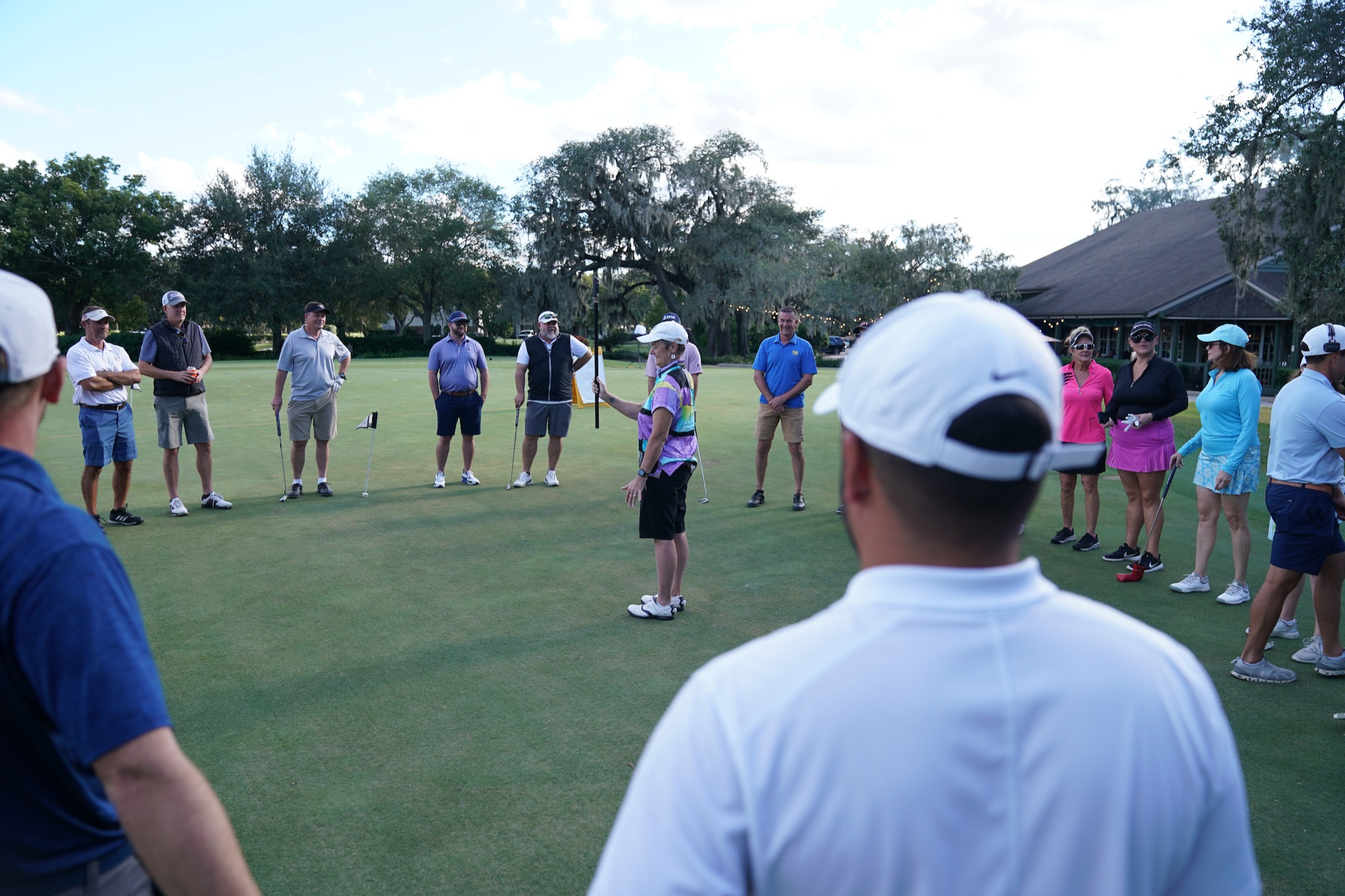 A small group lesson with a coach on the putting green