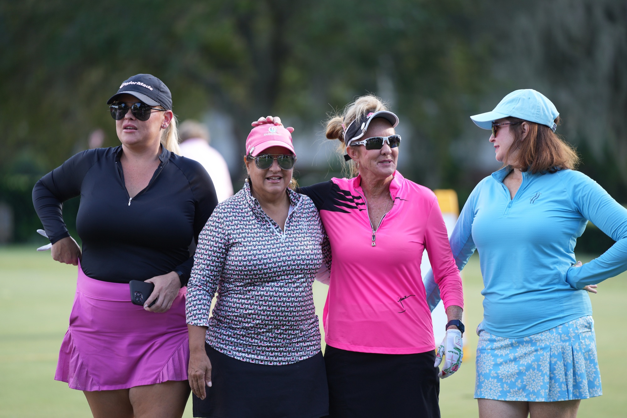 Friends arm in arm on the course